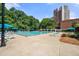 Community swimming pool with lounge chairs, umbrellas, and nearby high-rise building at 375 Ralph Mcgill Ne Blvd # 707, Atlanta, GA 30312