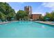 Community swimming pool featuring lounge chairs, umbrellas, and adjacent pergola at 375 Ralph Mcgill Ne Blvd # 707, Atlanta, GA 30312