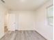 Bright bedroom features white walls, gray wood-look flooring, and a window at 500 Pomoma Circle Sw, Atlanta, GA 30315