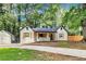 Charming home with wooden shutters and a spacious driveway surrounded by mature trees at 500 Pomoma Circle Sw, Atlanta, GA 30315