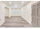 Bright living room features freshly painted walls, modern gray vinyl flooring, and a new front door at 500 Pomoma Circle Sw, Atlanta, GA 30315