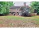 Spacious backyard with a well-maintained lawn, wooden fence, and a charming two-story home at 5765 Woodstone Dr, Cumming, GA 30028