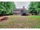 Extensive backyard with lush lawn, privacy fence, and a cozy patio visible from the house at 5765 Woodstone Dr, Cumming, GA 30028