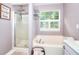 Bathroom featuring a walk in shower and a soaking tub at 5765 Woodstone Dr, Cumming, GA 30028
