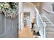 Welcoming entryway boasts hardwood floors, a staircase, a decorative wreath, and neutral paint at 5765 Woodstone Dr, Cumming, GA 30028