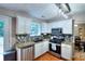 Modern kitchen featuring granite countertops, stainless steel appliances, white cabinets, and stylish backsplash at 5765 Woodstone Dr, Cumming, GA 30028
