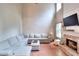Spacious living room featuring a large sectional sofa, fireplace, and open floor plan at 5765 Woodstone Dr, Cumming, GA 30028