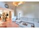 Bright living room featuring a large sectional sofa, tall ceilings, and seamless flow to the kitchen at 5765 Woodstone Dr, Cumming, GA 30028