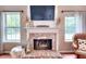 Cozy living room showcases a brick fireplace, decorative mantel, and natural light at 5765 Woodstone Dr, Cumming, GA 30028