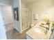 Well-lit bathroom features double sinks, granite countertops, and a glass-enclosed shower at 6011 Pine Bluff Pl, Conyers, GA 30013