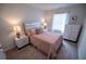 Cozy bedroom with a neatly made bed, side tables with lamps, and a chest of drawers offering a comfortable and organized space at 6011 Pine Bluff Pl, Conyers, GA 30013