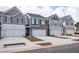 Attractive townhome exteriors showcasing modern architectural design and attached garages for convenient parking at 6011 Pine Bluff Pl, Conyers, GA 30013