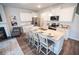 Bright kitchen featuring white cabinets, granite countertops, stainless steel appliances, and a large island with bar seating at 6011 Pine Bluff Pl, Conyers, GA 30013