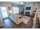 Comfortable living room with a fireplace, hardwood floors, and large windows offering plenty of natural light at 6011 Pine Bluff Pl, Conyers, GA 30013