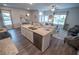 Open-concept living space featuring hardwood floors, a kitchen island, and abundant natural light from large windows at 6011 Pine Bluff Pl, Conyers, GA 30013