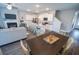 Open-concept living space with a modern kitchen, dining area, and a comfortable living room with a fireplace at 6011 Pine Bluff Pl, Conyers, GA 30013