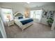 This main bedroom features a large window with lots of natural light and a luxurious king-size bed at 6011 Pine Bluff Pl, Conyers, GA 30013