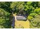 Aerial perspective of the home nestled in a verdant setting, with a long driveway and plenty of trees at 6133 Post Rd, Douglasville, GA 30135