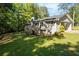 Home exterior view highlighting a spacious backyard and a convenient carport at 6133 Post Rd, Douglasville, GA 30135