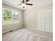 Bedroom features a ceiling fan, closet and backyard view at 6133 Post Rd, Douglasville, GA 30135