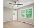 Bedroom featuring a ceiling fan and a window with a backyard view at 6133 Post Rd, Douglasville, GA 30135