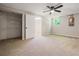 Bedroom with carpet, ceiling fan, closet with shelving, and view to the outside at 6133 Post Rd, Douglasville, GA 30135