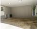 Carport featuring concrete floor, grey wood panelling, and steps leading to door at 6133 Post Rd, Douglasville, GA 30135