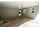 Carport featuring concrete floor, grey wood panelling, and view to back yard at 6133 Post Rd, Douglasville, GA 30135