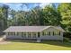 Well-maintained single-story home featuring a welcoming front porch, neat landscaping, and a classic design at 6133 Post Rd, Douglasville, GA 30135
