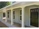 Inviting covered front porch with painted brick and white columns creates an appealing entrance at 6133 Post Rd, Douglasville, GA 30135