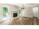 Living room showcasing a brick fireplace, hardwood floors, and a view of the backyard deck at 6133 Post Rd, Douglasville, GA 30135