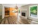 Living area view to kitchen shows fireplace and hardwood floors at 6133 Post Rd, Douglasville, GA 30135