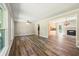 Spacious living room with hardwood floors, large windows, and a charming brick fireplace at 6133 Post Rd, Douglasville, GA 30135