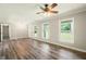 Bright and airy living room featuring hardwood floors, natural light, and a modern ceiling fan at 6133 Post Rd, Douglasville, GA 30135