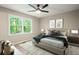 Main bedroom featuring a large window, ceiling fan and neutral decor at 6133 Post Rd, Douglasville, GA 30135