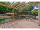 Relaxing back deck with pergola, dark metal railings, seating area, and fenced-in backyard at 700 Mill Creek Cv, Canton, GA 30115