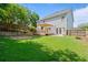 Back exterior view of a home with a large, well-maintained lawn and a wooden deck at 700 Mill Creek Cv, Canton, GA 30115