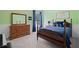 Bedroom with wooden furniture, a window with curtains, and light-green colored walls at 700 Mill Creek Cv, Canton, GA 30115