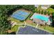 Aerial view of tennis courts, pool, and playground within a beautifully landscaped community at 700 Mill Creek Cv, Canton, GA 30115