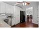 Modern kitchen showcasing white cabinets, stainless steel appliances, and stylish gray countertops at 700 Mill Creek Cv, Canton, GA 30115