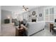 Open living room featuring a fireplace, ceiling fan, and comfortable seating area, perfect for relaxation and entertaining at 700 Mill Creek Cv, Canton, GA 30115