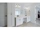 Bathroom featuring a double sink vanity with storage, framed mirrors, and neutral tones at 700 Mill Creek Cv, Canton, GA 30115