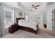 Bright main bedroom with a ceiling fan, a large window, a walk-in closet, and soft, neutral tones at 700 Mill Creek Cv, Canton, GA 30115