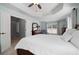 Main bedroom offering a tray ceiling, natural light, a window view, and a cozy, inviting atmosphere at 700 Mill Creek Cv, Canton, GA 30115