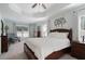 Spacious main bedroom showcasing a tray ceiling, a large window, and ample natural light at 700 Mill Creek Cv, Canton, GA 30115