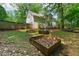 Spacious backyard with a two-story home, landscaping features, and privacy fence at 701 Robert Ln, Canton, GA 30114