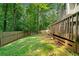 A backyard with a wooden fence and a deck connected to the house at 701 Robert Ln, Canton, GA 30114