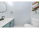 Compact half bath features modern fixtures and floating shelves at 701 Robert Ln, Canton, GA 30114