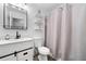 Stylishly updated bathroom features a modern vanity, shelves, and shower with a patterned curtain at 701 Robert Ln, Canton, GA 30114