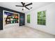 Bright bedroom with chalkboard wall, ceiling fan, and closet with shelving at 701 Robert Ln, Canton, GA 30114